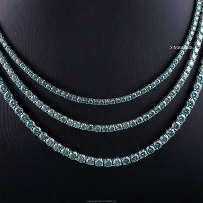 Shiny 3 layers of green and blue Moissanite diamond tennis chain necklaces on a dark background, showcasing elegance.