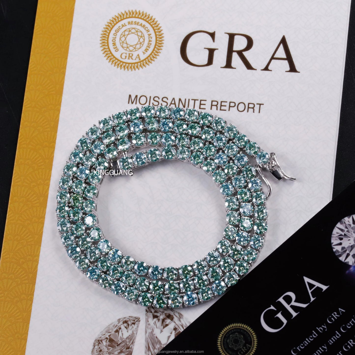 Shiny moissanite tennis bracelet with green and blue diamonds on GRA report background, highlighting elegance and quality.
