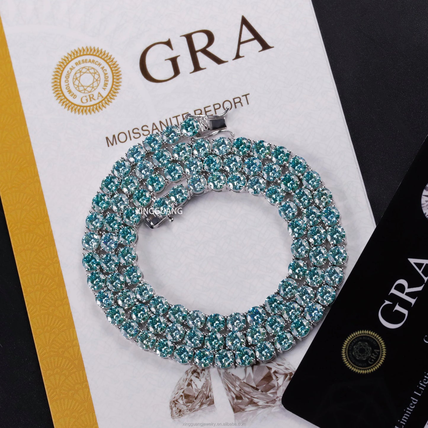 Moissanite tennis chain bracelet with shiny green and blue diamonds on a GRA Moissanite report background.